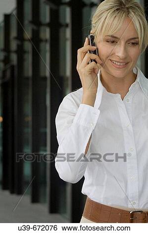 Woman talking on a mobile phone. View Large Photo Image Stock Photograph - Woman talking on a mobile phone.. Fotosearch