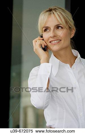 Woman talking on a mobile phone. View Large Photo Image Stock Photography - Woman talking on a mobile phone.. Fotosearch