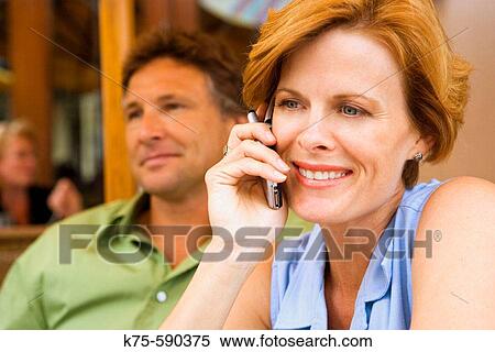 Woman talking on cell phone View Large Photo Image Stock Photography - Woman talking on cell phone. Fotosearch