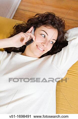 Woman talking on the phone on couch View Large Photo Image Stock Image - Woman talking on the phone on couch. Fotosearch