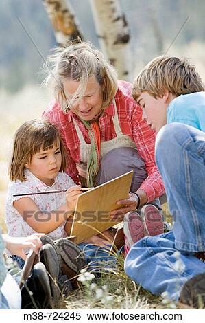 Woman teaching kids to paint, Lone Mt Ranch, Big Sky, Montana, USA View Large Photo Image Stock Photography - Woman teaching kids to paint, Lone Mt Ranch, Big Sky, Montana, USA. Fotosearch
