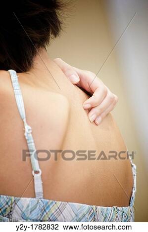 Woman touching her back View Large Photo Image Stock Image - Woman touching her back. Fotosearch