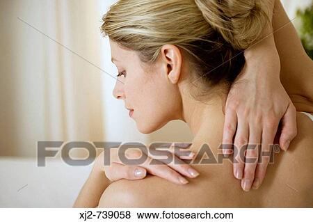Woman touching her back View Large Photo Image Stock Photo - Woman touching her back. Fotosearch