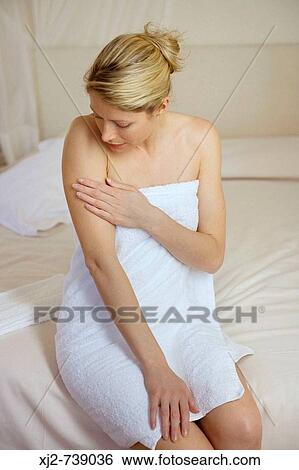 Stock Photograph - Woman touching her skin. Fotosearch