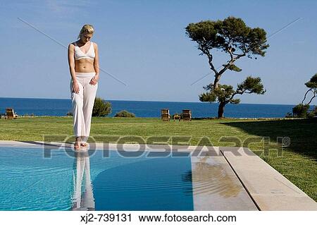 Woman touching the water with her foot View Large Photo Image Stock Image - Woman touching the water with her foot. Fotosearch