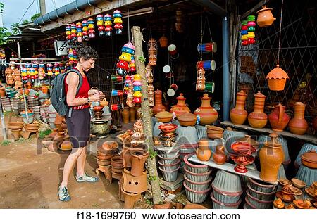 Woman tourist browsing local pottery for sale at street side market, Weligama, Sri Lanka View Large Photo Image Stock Image - Woman tourist browsing local pottery for sale at street side market, Weligama, Sri Lanka. Fotosearch