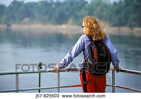 Woman tourist looking at river from boat, Guilin. China. View Large Photo Image Stock Image - Woman tourist looking at river from boat, Guilin. China.. Fotosearch