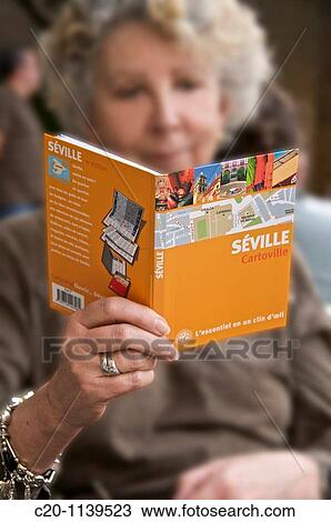 woman tourist reading a guide book of Sevilla Andalucia Spain View Large Photo Image Stock Image - woman tourist reading a guide book of Sevilla Andalucia Spain. Fotosearch
