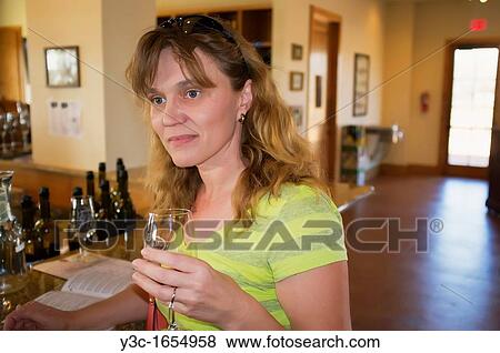 Woman trying different kinds of wine at a wine tasting event View Large Photo Image Stock Photo - Woman trying different kinds of wine at a wine tasting event. Fotosearch