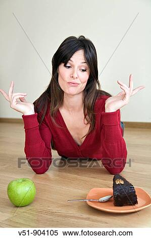 Stock Photography - Woman, undecided, food, young adult. Fotosearch