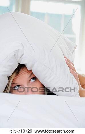 woman under pillow scared View Large Photo Image Stock Photo - woman under pillow scared. Fotosearch