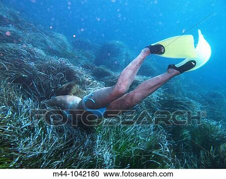 Stock Image - Woman underwater. Fotosearch