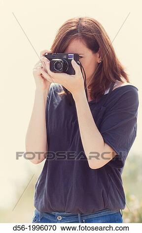 woman using a camera View Large Photo Image Stock Image - woman using a camera. Fotosearch