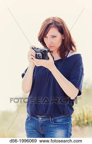woman using a camera View Large Photo Image Stock Photo - woman using a camera. Fotosearch