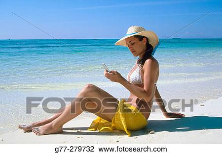 Woman using a mobile on a beach. White Sands Resort and Spa. Ari Atoll. Maldives View Large Photo Image Stock Image - Woman using a mobile on a beach. White Sands Resort and Spa. Ari Atoll. Maldives. Fotosearch