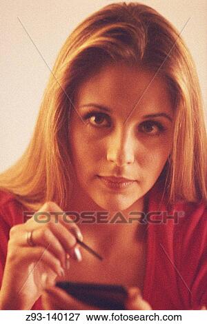 Stock Photo - Woman using a Personal Digital Assistant. Fotosearch
