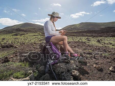 Woman using a Tablet at Timanfaya National Park, Lanzarote, Canary Islands, Spain. View Large Photo Image Stock Image - Woman using a Tablet at Timanfaya National Park, Lanzarote, Canary Islands, Spain.. Fotosearch