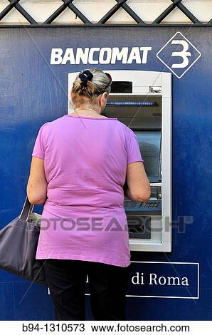 Woman using an ATM, Rome, Italy View Large Photo Image Stock Image - Woman using an ATM, Rome, Italy. Fotosearch