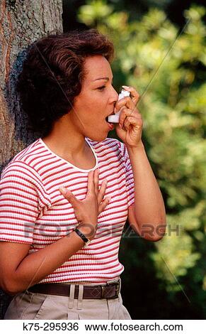 woman using an inhaler View Large Photo Image Stock Photograph - woman using an inhaler. Fotosearch