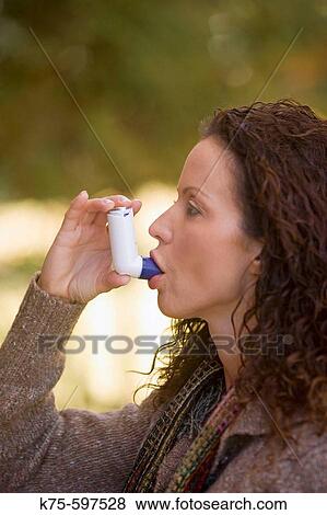 Woman using bronchial inhaler View Large Photo Image Stock Photo - Woman using bronchial inhaler. Fotosearch