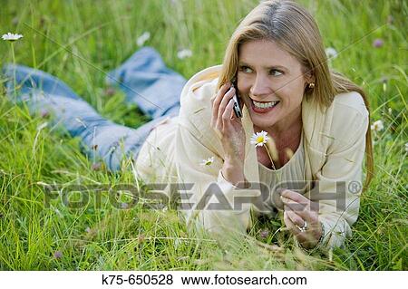 woman using cell phone in field View Large Photo Image Stock Photo - woman using cell phone in field. Fotosearch