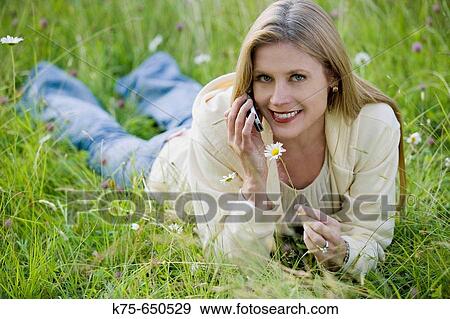Stock Photo - woman using cell phone outdoors. Fotosearch
