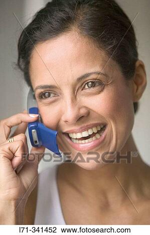 Stock Image - Woman using cell phone. Fotosearch
