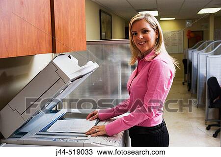 Woman using copy machine in office View Large Photo Image Stock Image - Woman using copy machine in office. Fotosearch