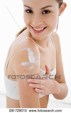 Stock Photography - Woman Using cream. Fotosearch