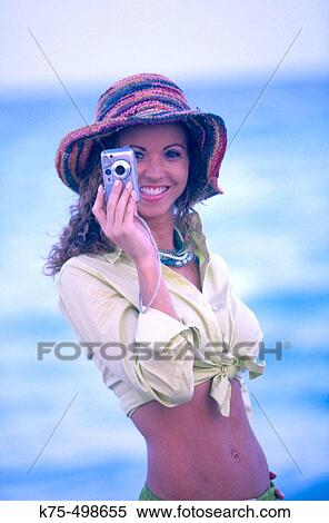 Woman using digital camera at beach View Large Photo Image Stock Photography - Woman using digital camera at beach. Fotosearch