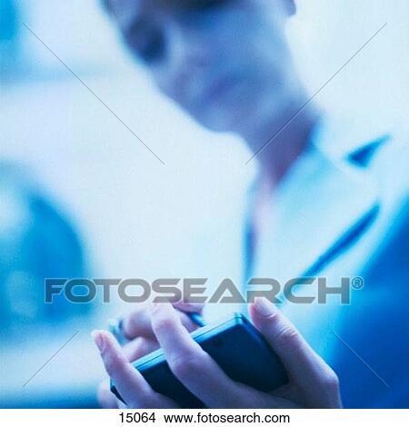 Picture - Woman using electronic organizer. Fotosearch