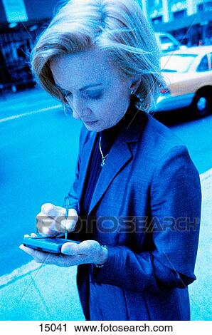 Woman using electronic organizer View Large Photo Image Stock Image - Woman using electronic organizer. Fotosearch