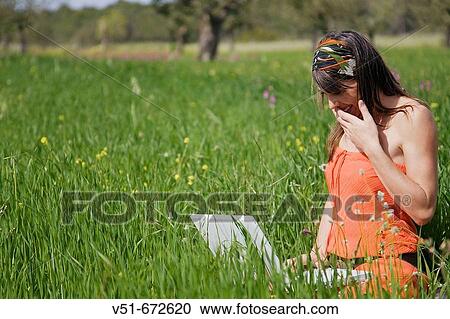 Woman using laptop in the countryside View Large Photo Image Stock Image - Woman using laptop in the countryside. Fotosearch