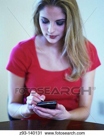Stock Image - Woman using PDA. Fotosearch