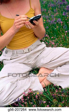Picture - Woman using pocket organizer. Fotosearch