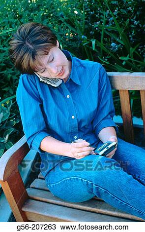 Woman using pocket organizer View Large Photo Image Stock Image - Woman using pocket organizer. Fotosearch