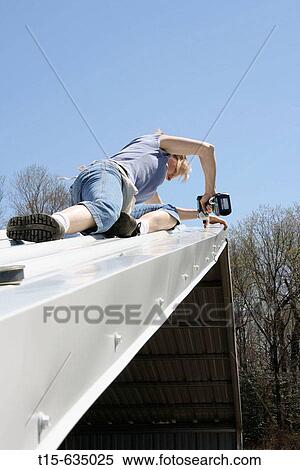 Woman using power drill fixing roof View Large Photo Image Stock Photography - Woman using power drill fixing roof. Fotosearch