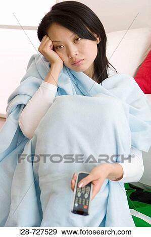 Woman using television remote control View Large Photo Image Stock Photo - Woman using television remote control. Fotosearch