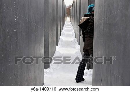 Stock Photograph - Woman visiting Monument to the Murdered Jews of Europe, Berlin, Germany. Fotosearch