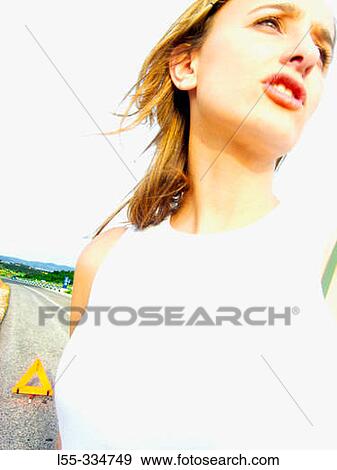 Stock Photo - Woman waiting for road assistance. Fotosearch