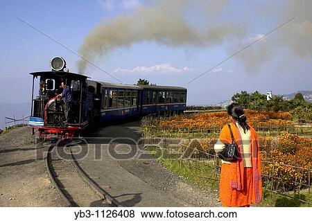 Woman waiting for the Darjeeling Himalayan Railway Toy Train, Darjeeling, West Bengal, India View Large Photo Image Stock Photo - Woman waiting for the Darjeeling Himalayan Railway Toy Train, Darjeeling, West Bengal, India. Fotosearch