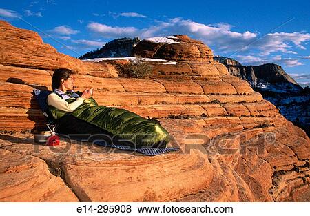 Woman waking up with sunrise at Zion National Park. Utah, USA View Large Photo Image Stock Photo - Woman waking up with sunrise at Zion National Park. Utah, USA. Fotosearch