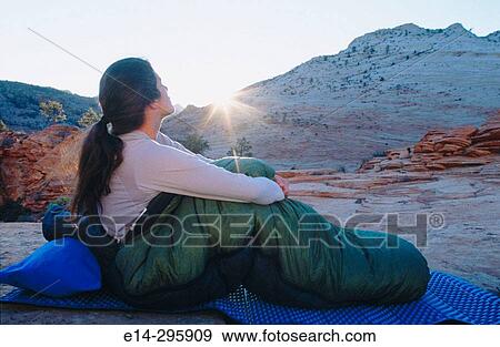 Woman waking up with sunrise at Zion National Park. Utah, USA View Large Photo Image Stock Photo - Woman waking up with sunrise at Zion National Park. Utah, USA. Fotosearch