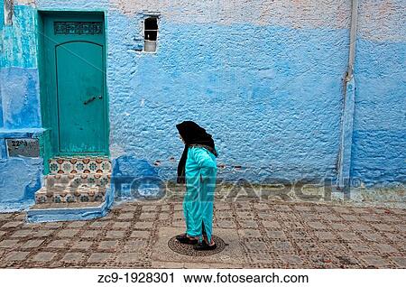 Woman walking by the streets of the blue medina of Chefchaouen Rif region, Morocco View Large Photo Image Stock Image - Woman walking by the streets of the blue medina of Chefchaouen Rif region, Morocco. Fotosearch