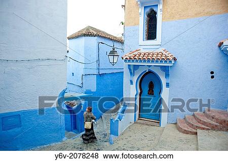 Woman walking in a street. Chefchaouen, Morocco. View Large Photo Image Stock Photo - Woman walking in a street. Chefchaouen, Morocco.. Fotosearch