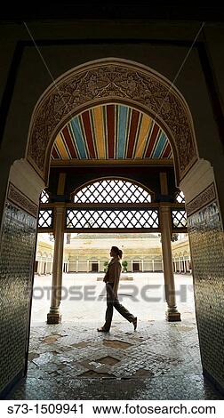 Stock Image - Woman walking in Bahia palace, Marrakech, Morocco. Fotosearch