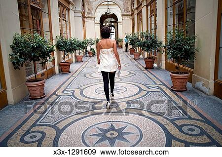 Stock Photo - Woman walking in Galerie Vivienne Paris France. Fotosearch