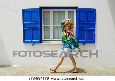 Woman walking in Mykonos, Cyclades Islands, Greece View Large Photo Image Stock Photo - Woman walking in Mykonos, Cyclades Islands, Greece. Fotosearch