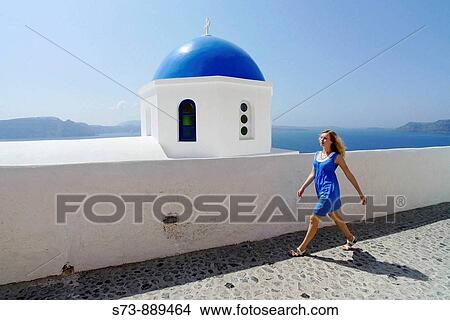 Woman walking in O? a, Santorini. Cyclades. Greece. View Large Photo Image Picture - Woman walking in O? a, Santorini. Cyclades. Greece.. Fotosearch