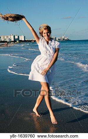 Woman walking next to seaside View Large Photo Image Stock Image - Woman walking next to seaside. Fotosearch